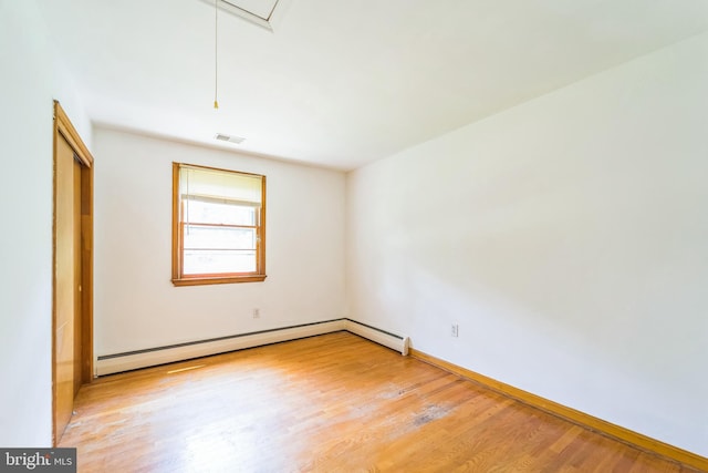 892 Timber Ridge Dr, Hanover, MD 21076 - empty room with attic access, light wood-style flooring, and a baseboard heating unit