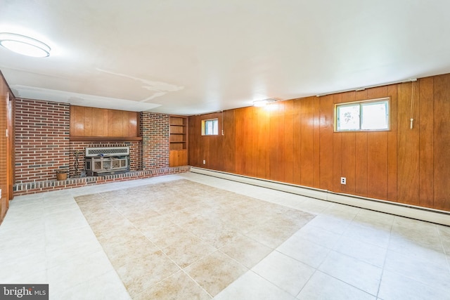 892 Timber Ridge Dr, Hanover, MD 21076 - below grade area with a baseboard radiator, heating unit, plenty of natural light, a brick fireplace, and wood walls