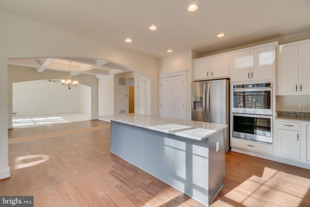 2 Bluebird Ln, Stafford, VA 22554 - kitchen featuring appliances with stainless steel finishes, recessed lighting, a chandelier, a center island, and arched walkways