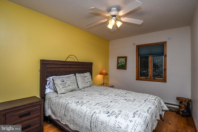 1140 Rock Lodge Rd, Mc Henry, MD 21541 - bedroom featuring wood finished floors, ceiling fan, and a baseboard heating unit