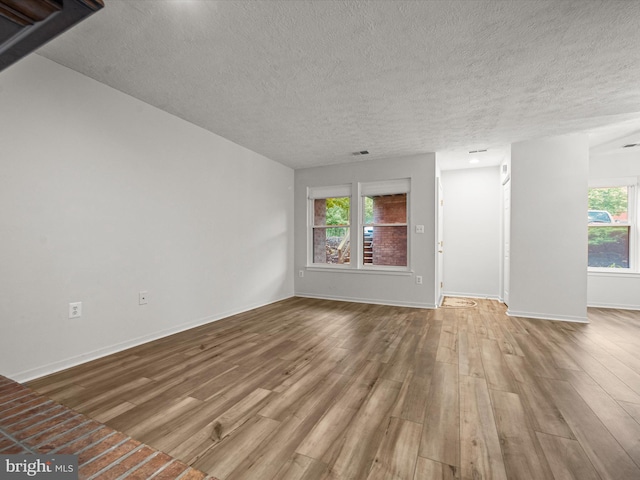 7607 Weather Worn Way Unit A, Columbia, MD 21046 - unfurnished living room featuring a textured ceiling and wood finished floors