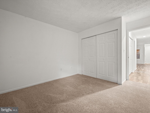 7607 Weather Worn Way Unit A, Columbia, MD 21046 - unfurnished bedroom with light colored carpet, a closet, and a textured ceiling