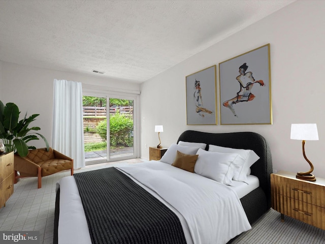 7607 Weather Worn Way Unit A, Columbia, MD 21046 - carpeted bedroom featuring a textured ceiling