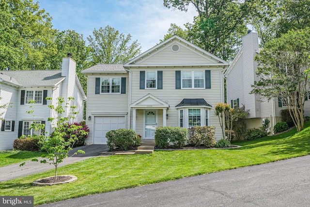 10034 Park Woods Ln, Burke, VA 22015 - view of front of home with an attached garage, asphalt driveway, and a front yard