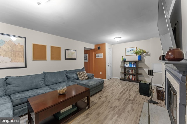 10034 Park Woods Ln, Burke, VA 22015 - living area featuring light wood-type flooring and a fireplace with flush hearth