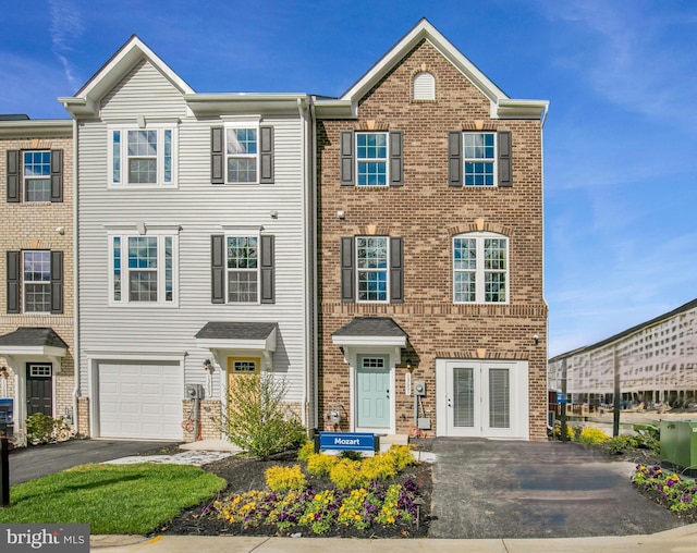 13626 Corinthian Ln Unit D-F02006D, Brandywine, MD 20613 - townhome / multi-family property with driveway, brick siding, an attached garage, and french doors