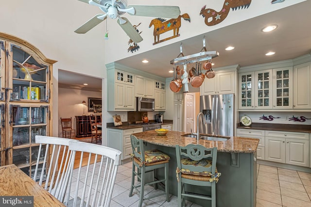 4 Surrey Rd, Rehoboth Beach, DE 19971 - kitchen with stainless steel appliances, light tile patterned flooring, ceiling fan, a breakfast bar, and recessed lighting