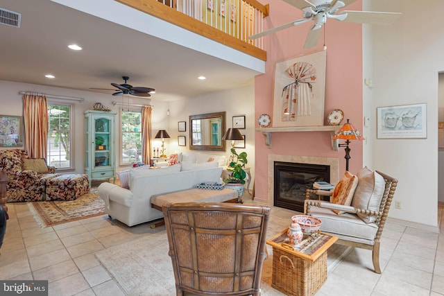 4 Surrey Rd, Rehoboth Beach, DE 19971 - living room featuring ceiling fan, a tiled fireplace, recessed lighting, light tile patterned flooring, and a towering ceiling
