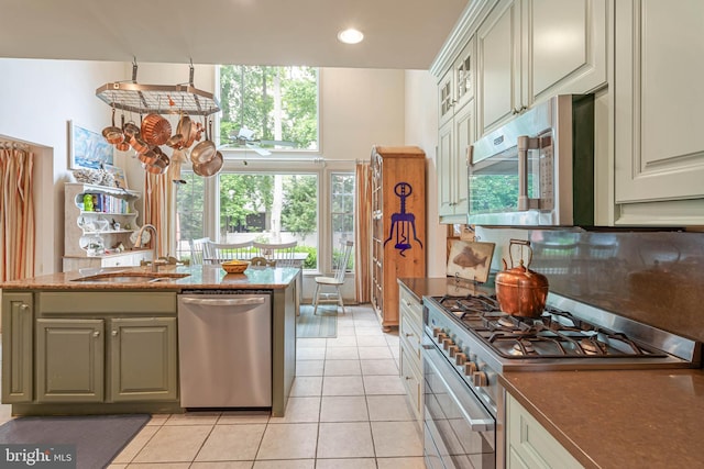 4 Surrey Rd, Rehoboth Beach, DE 19971 - kitchen featuring appliances with stainless steel finishes, light tile patterned floors, glass insert cabinets, recessed lighting, and dark stone countertops