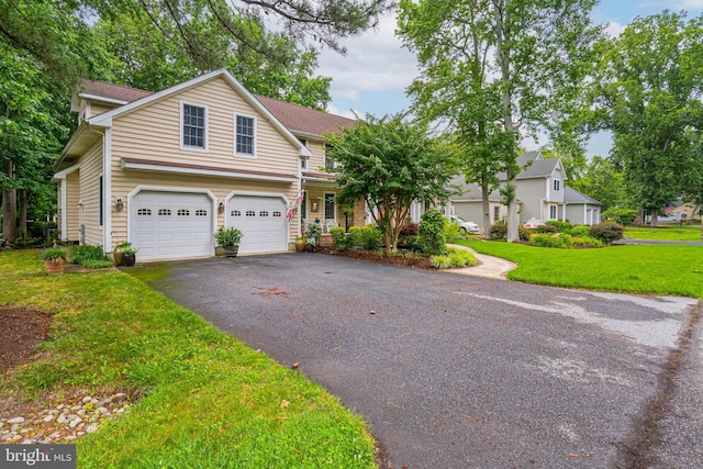 4 Surrey Rd, Rehoboth Beach, DE 19971 - view of front facade with driveway, a front lawn, and an attached garage