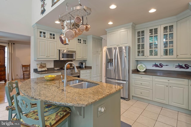 4 Surrey Rd, Rehoboth Beach, DE 19971 - kitchen with stainless steel appliances, a breakfast bar, glass insert cabinets, dark stone counters, and recessed lighting