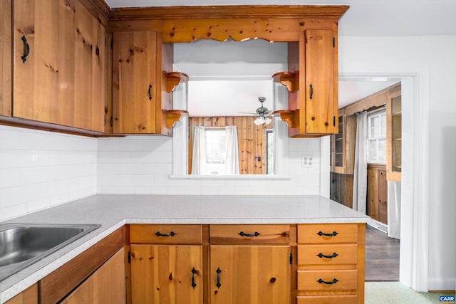 2504 Plateau Rd, Charlottesville, VA 22903 - kitchen with light countertops, decorative backsplash, brown cabinets, and a ceiling fan