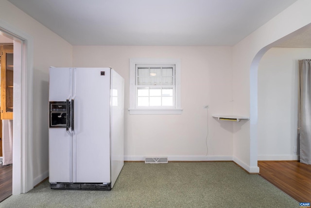 2504 Plateau Rd, Charlottesville, VA 22903 - kitchen with white refrigerator with ice dispenser, arched walkways, and carpet floors