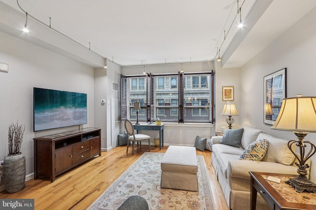 1425 Locust St Unit 7D, Philadelphia, PA 19102 - living room featuring wood finished floors, rail lighting, and a desk