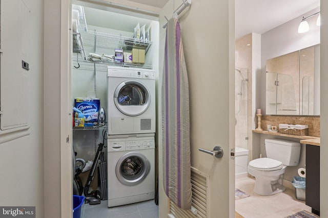 1425 Locust St Unit 7D, Philadelphia, PA 19102 - laundry room featuring stacked washer / dryer and tile patterned floors