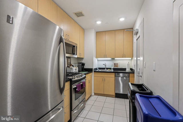 1425 Locust St Unit 7D, Philadelphia, PA 19102 - kitchen with appliances with stainless steel finishes, dark countertops, light tile patterned floors, light brown cabinetry, and recessed lighting