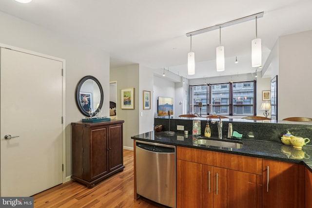 1425 Locust St Unit 7D, Philadelphia, PA 19102 - kitchen with stainless steel dishwasher, wood finished floors, dark stone countertops, and decorative light fixtures