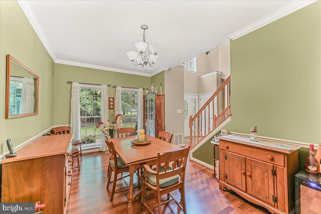 117 Woodrow Ln, Port Deposit, MD 21904 - dining area featuring a chandelier, wood finished floors, stairs, and ornamental molding