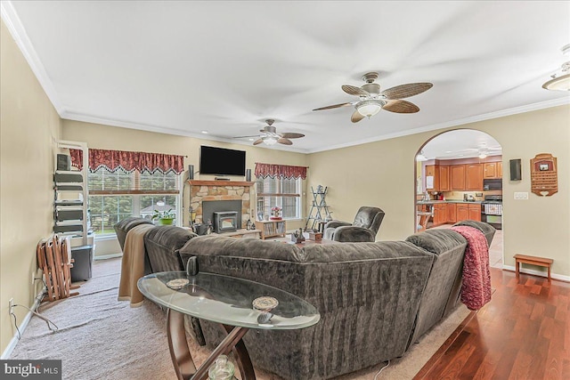 117 Woodrow Ln, Port Deposit, MD 21904 - living area with a ceiling fan, wood finished floors, crown molding, arched walkways, and a fireplace