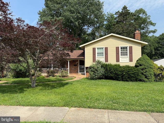 7400 Roxbury Ave, Manassas, VA 20109 - tri-level home featuring a chimney, a front lawn, and covered porch
