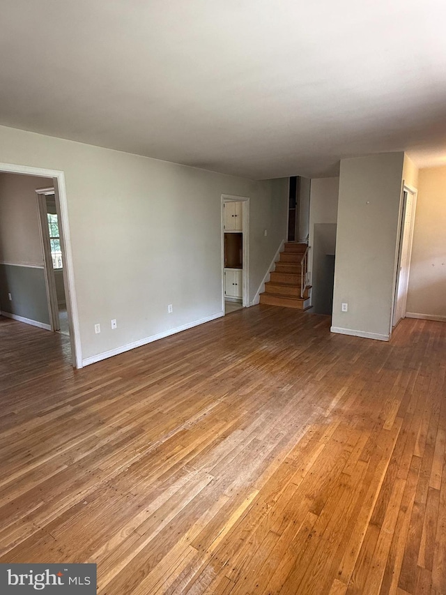 7400 Roxbury Ave, Manassas, VA 20109 - unfurnished living room with hardwood / wood-style flooring and stairs