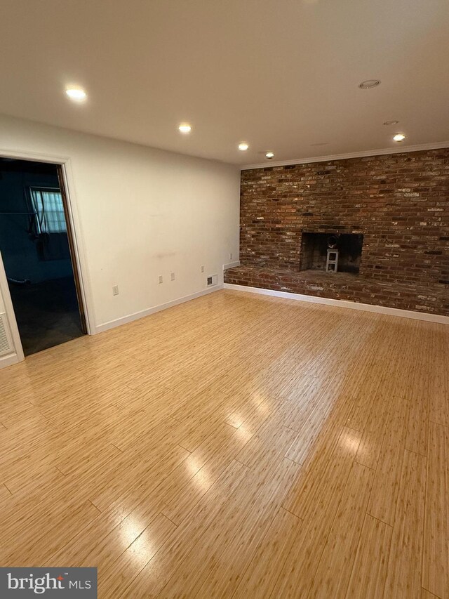 7400 Roxbury Ave, Manassas, VA 20109 - unfurnished living room featuring recessed lighting, a brick fireplace, and wood finished floors