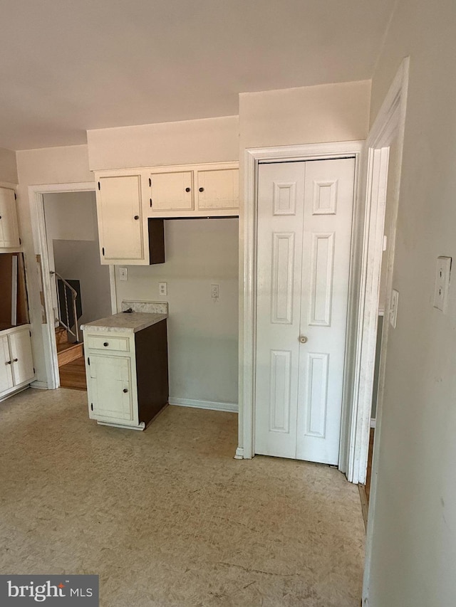 7400 Roxbury Ave, Manassas, VA 20109 - kitchen featuring light carpet and white cabinetry