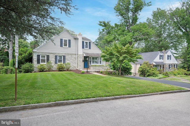 12 Rodney Rd, Bryn Mawr, PA 19010 - view of front of property featuring stone siding, a front yard, and a chimney
