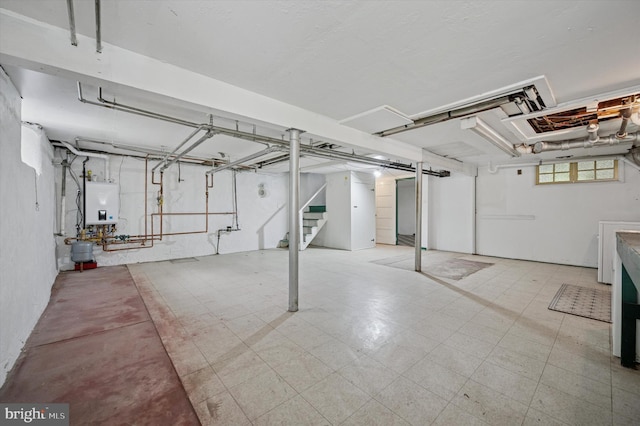 12 Rodney Rd, Bryn Mawr, PA 19010 - basement featuring tankless water heater, stairs, and tile patterned floors