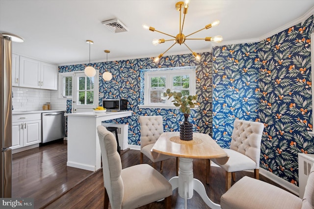 12 Rodney Rd, Bryn Mawr, PA 19010 - dining room with wallpapered walls, a chandelier, healthy amount of natural light, dark wood-style flooring, and crown molding