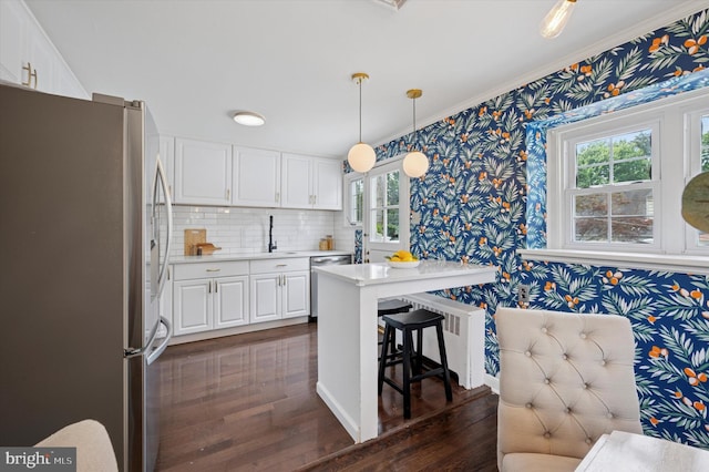 12 Rodney Rd, Bryn Mawr, PA 19010 - kitchen with appliances with stainless steel finishes, wallpapered walls, dark wood-style floors, light countertops, and white cabinetry