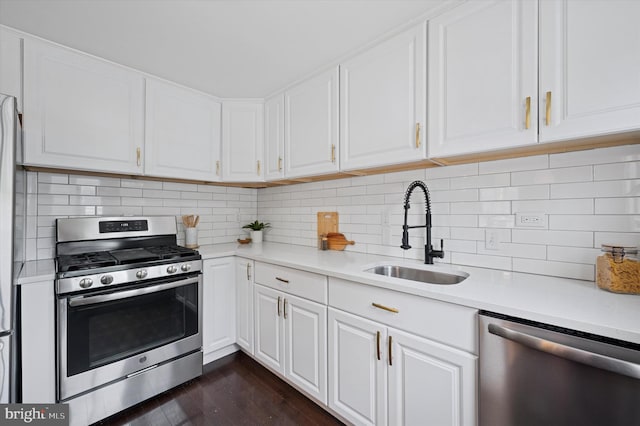 12 Rodney Rd, Bryn Mawr, PA 19010 - kitchen with stainless steel appliances, light countertops, white cabinets, and dark wood finished floors