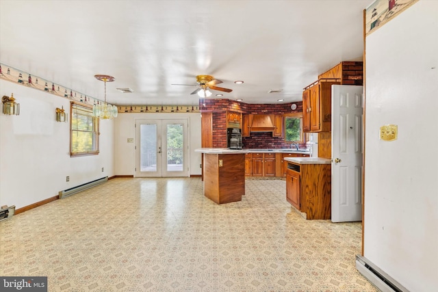 26140 High Banks Dr, Salisbury, MD 21801 - kitchen featuring a baseboard heating unit, brown cabinets, light countertops, and oven