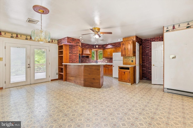 26140 High Banks Dr, Salisbury, MD 21801 - kitchen with freestanding refrigerator, a ceiling fan, light countertops, a peninsula, and brown cabinetry