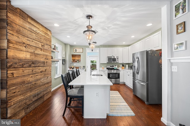 4334 Mitchell St, Philadelphia, PA 19128 - kitchen featuring stainless steel appliances, light countertops, white cabinets, hanging light fixtures, and recessed lighting