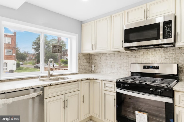 1171 E Sharpnack St, Philadelphia, PA 19150 - kitchen with appliances with stainless steel finishes, tasteful backsplash, and light stone countertops