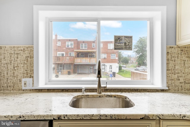 1171 E Sharpnack St, Philadelphia, PA 19150 - kitchen view of decorative backsplash, light stone counters, and cream cabinetry