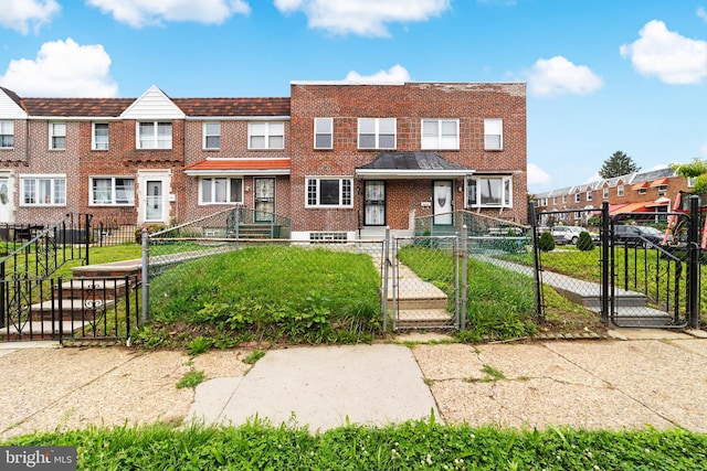 1171 E Sharpnack St, Philadelphia, PA 19150 - townhome / multi-family property featuring a gate, brick siding, and a fenced front yard