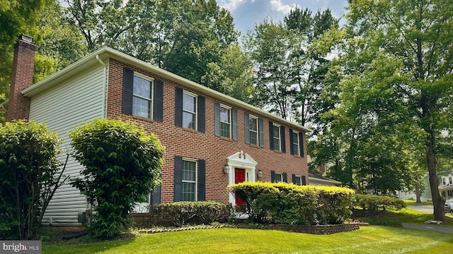 11531 Paramus Dr, North Potomac, MD 20878 - colonial-style house featuring a front lawn and a chimney