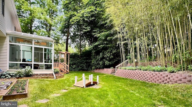 11531 Paramus Dr, North Potomac, MD 20878 - view of green lawn featuring a sunroom, stairs, and a garden