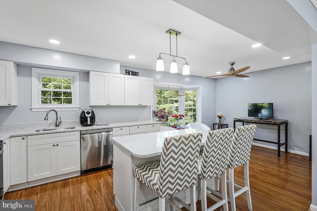 9126 Fisteris Ct, Springfield, VA 22152 - kitchen featuring stainless steel dishwasher, dark wood finished floors, a kitchen bar, white cabinets, and recessed lighting