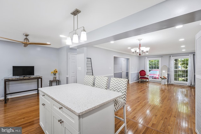 9126 Fisteris Ct, Springfield, VA 22152 - kitchen featuring open floor plan, a chandelier, white cabinetry, hardwood / wood-style floors, and pendant lighting