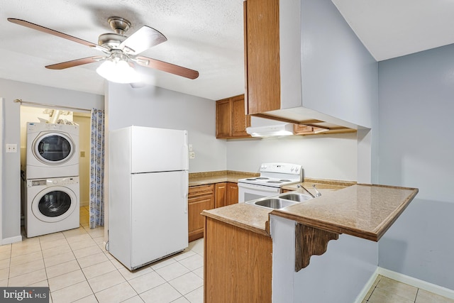 9126 Fisteris Ct, Springfield, VA 22152 - kitchen featuring white appliances, stacked washing machine and dryer, a peninsula, ceiling fan, and light tile patterned flooring