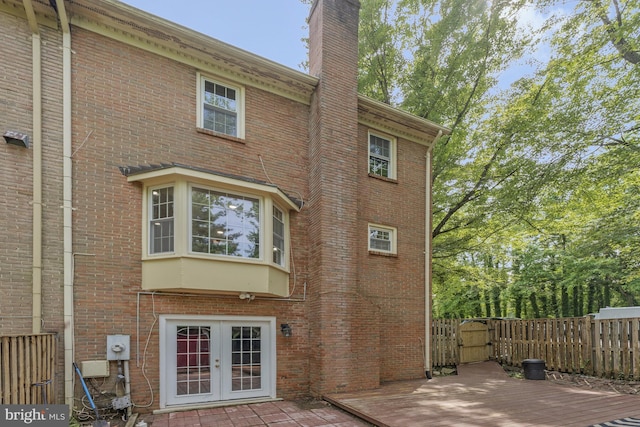 9126 Fisteris Ct, Springfield, VA 22152 - back of house with french doors, brick siding, a gate, a chimney, and a deck