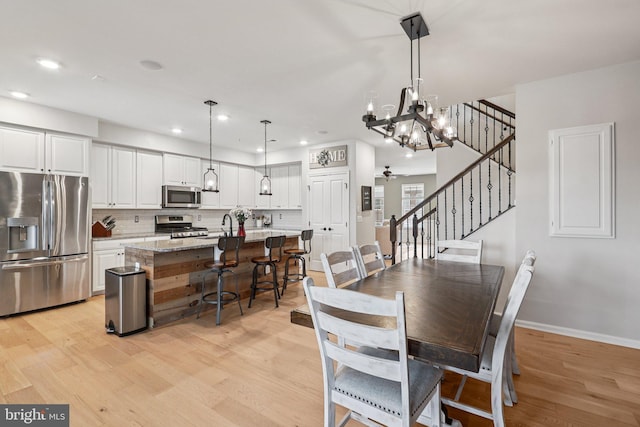 269 High Rail Ter SE, Leesburg, VA 20175 - dining area featuring a chandelier, light wood-type flooring, recessed lighting, and stairs