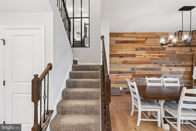 269 High Rail Ter SE, Leesburg, VA 20175 - stairs featuring a chandelier, wood walls, and hardwood / wood-style flooring