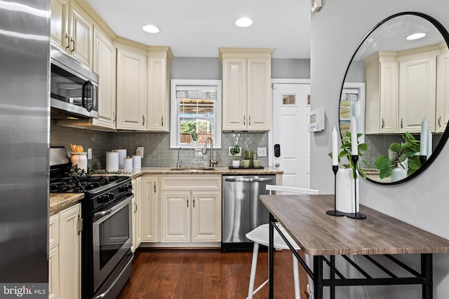 503 E Fort Ave, Baltimore, MD 21230 - kitchen featuring stainless steel appliances, light stone counters, dark wood-style flooring, decorative backsplash, and recessed lighting
