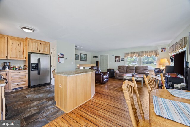 3341 Howellsville Rd, Front Royal, VA 22630 - kitchen with stainless steel fridge, light brown cabinetry, open floor plan, and light stone countertops