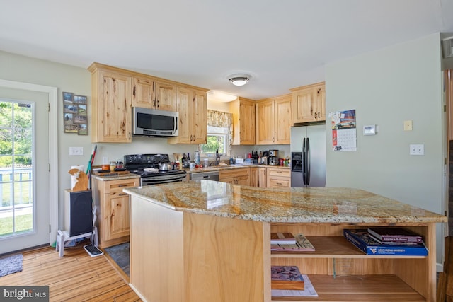 3341 Howellsville Rd, Front Royal, VA 22630 - kitchen featuring stainless steel appliances, light brown cabinetry, light stone countertops, and light wood-type flooring