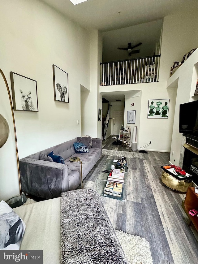 6541 Grange Ln Unit 401, Alexandria, VA 22315 - living area featuring wood finished floors, a ceiling fan, and a high ceiling